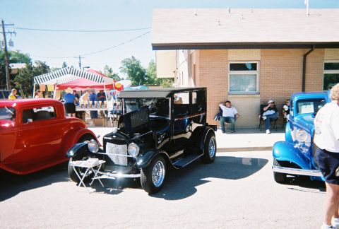 1972 Ford Ranchero - Several vintage cars are on display at an outdoor event with people milling around.