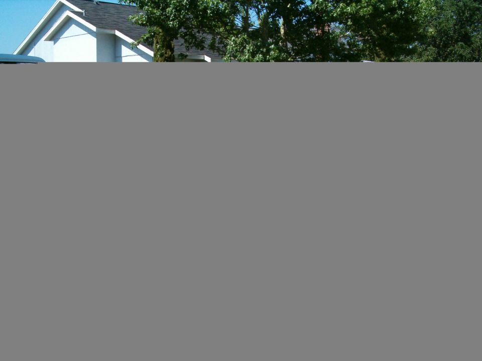 White SUV parked in front of a house