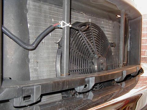 2002 Ford Excursion - An electric cooling fan is mounted in front of the radiator, with wiring connected.