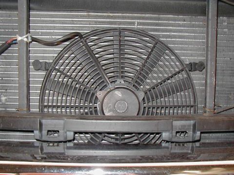 2002 Ford Excursion - Close-up view of an aftermarket electric cooling fan installed in front of a vehicle's radiator assembly.