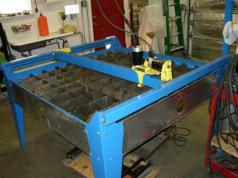 1995 Ford Bronco - A blue metal cutting machine with a yellow motor assembly is shown in a workshop setting.