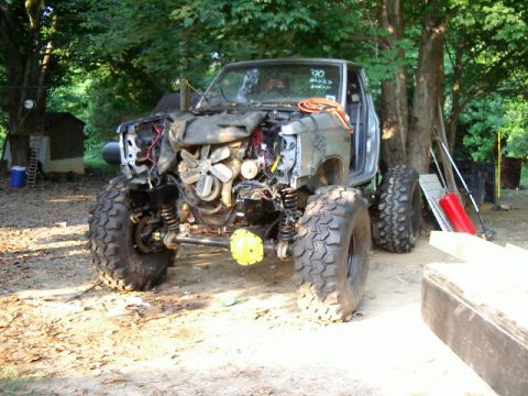 1985 Ford Bronco - This heavily modified truck is missing its front body panels, revealing the engine and suspension components.