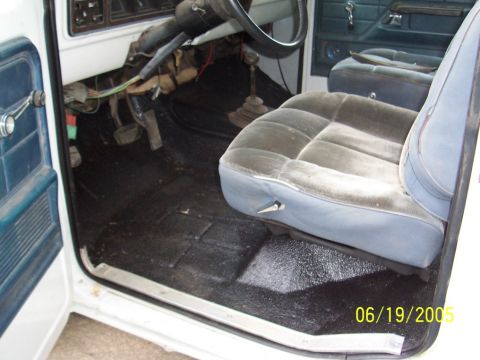 1979 Ford Bronco - The interior of a vehicle shows the driver's side floor, pedals, and part of the seats. A date stamp indicates the photo was taken on 06/19…