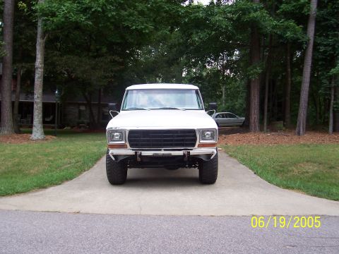 1979 Ford Bronco - This white Ford truck is parked in a driveway with trees and a house in the background. The date 06/19/2005 is visible.