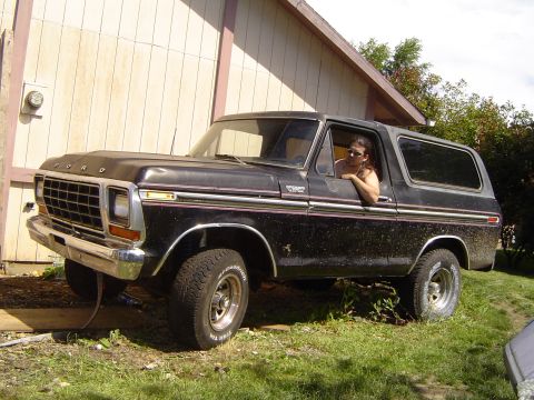 1979 Ford Bronco - A black 1978 Ford Bronco is parked in front of a building with a person in the driver's seat.
