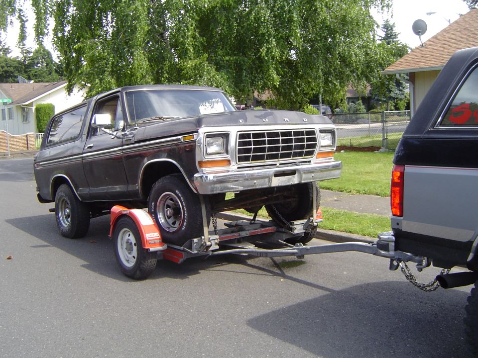 Black 1979 Ford Bronco on trailer, front 3/4 view