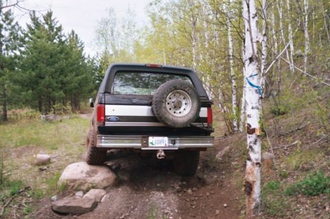 1996 Ford Bronco - This 1996 Ford Bronco is navigating a rocky, off-road trail in a wooded area.