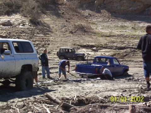 1985 Ford Bronco - Off-road vehicles stuck in mud, with a date stamp of 01/01/2002.