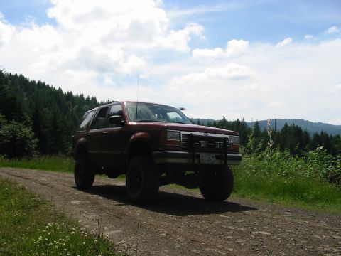 1991 Ford Explorer - A red 1991 Ford Explorer is seen driving on a dirt road during a trip to Courtney Creek.