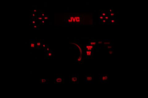 1997 Ford Probe - The dashboard of a car features red LED illumination for the gauges and a JVC radio, indicating an interior view.