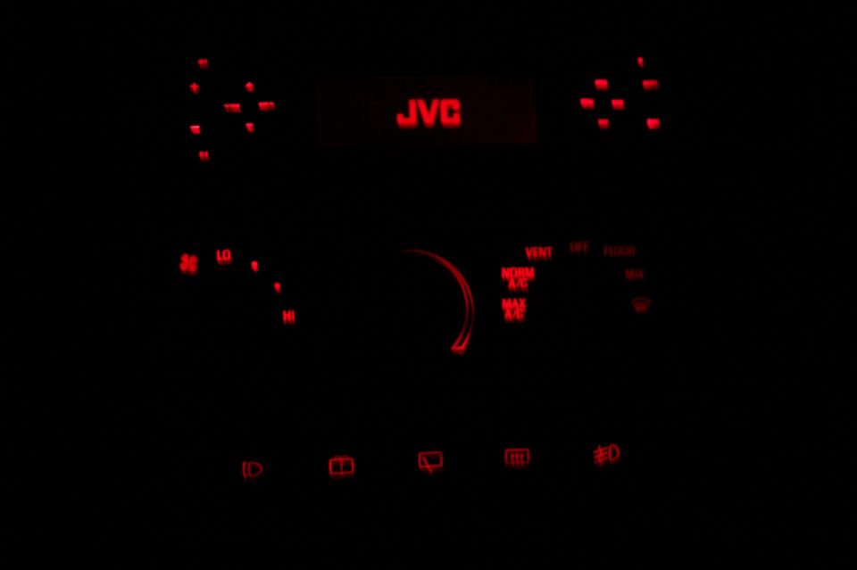Car interior dashboard with red LED lights and JVC radio display
