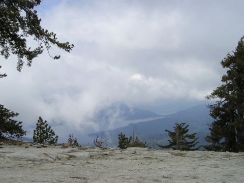 1989 Ford Bronco - A scenic view of mountains shrouded in clouds, with a Supermotors.net logo in the corner.
