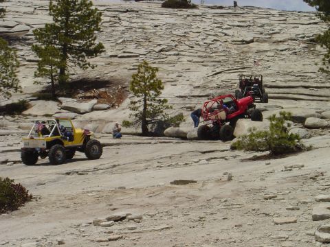 1989 Ford Bronco - Multiple off-road vehicles navigate a challenging rocky landscape.