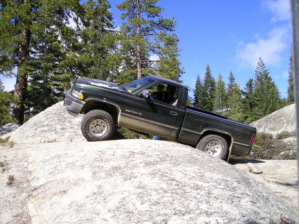 Dodge Ram 1500 pickup truck with V8 badge on rocks