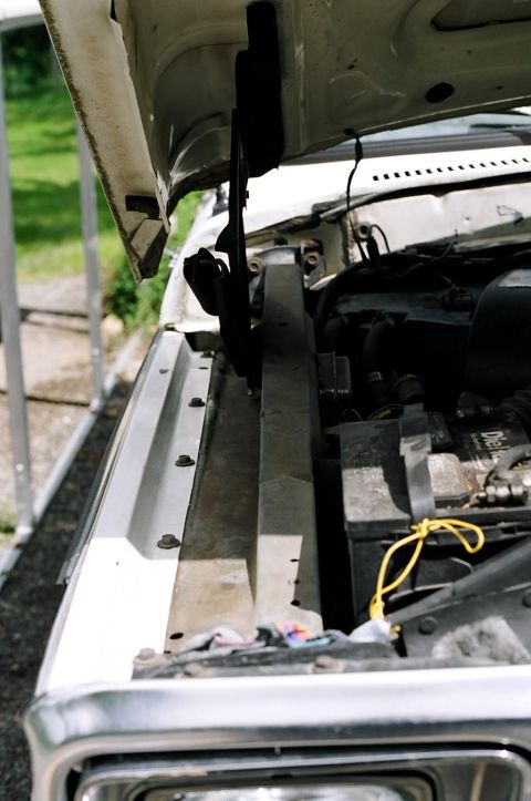 1979 Ford Bronco - Close-up view of the engine bay, showing the battery and radiator support structure.