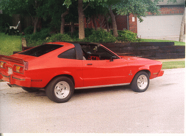 1978 Ford Mustang II - Side view of a red coupe parked outdoors.