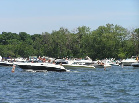 1997 Crownline 266 CCR - Boats are moored together on the water under a clear sky.