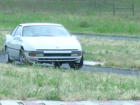 1993 Ford Probe - A 1993 Ford Probe is seen parked off-road near a track.