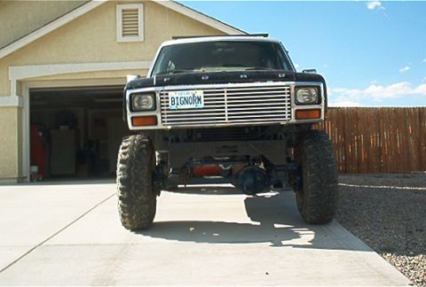 1986 Ford Bronco - This lifted 1986 Ford Bronco is parked in front of a garage.