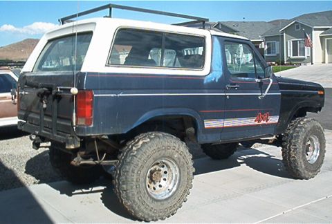 1986 Ford Bronco - This lifted 1986 Ford Bronco features a distinctive blue and white paint scheme with a 4x4 decal on the side.