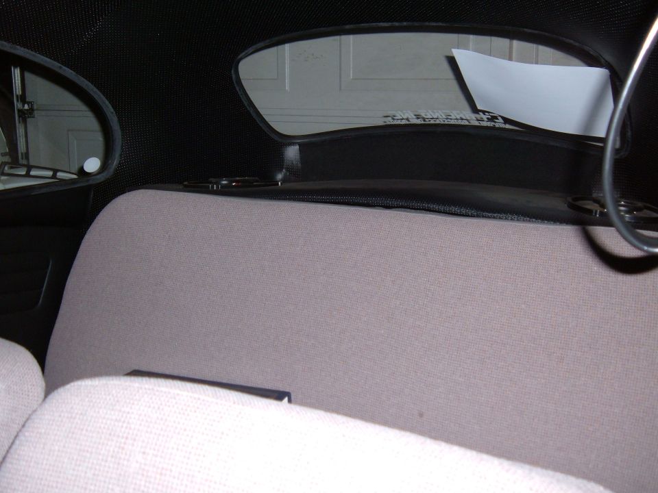 1964 Volkswagen Beetle interior with grey seats and a black headliner