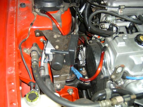 1989 Ford Probe - Engine bay components including hoses, wires, and a power steering fluid reservoir are shown in this close-up view.