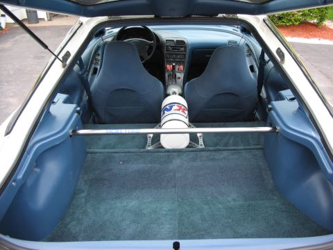1993 Ford Probe - Interior view of a 1993 Ford Probe, blue seats and a nitrous tank in the rear.