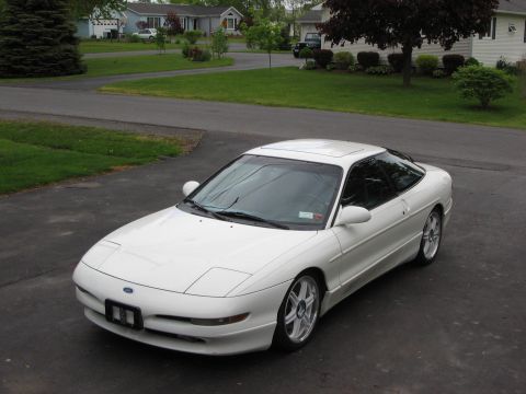 1993 Ford Probe - A white 1993 Ford Probe is parked in a suburban driveway.