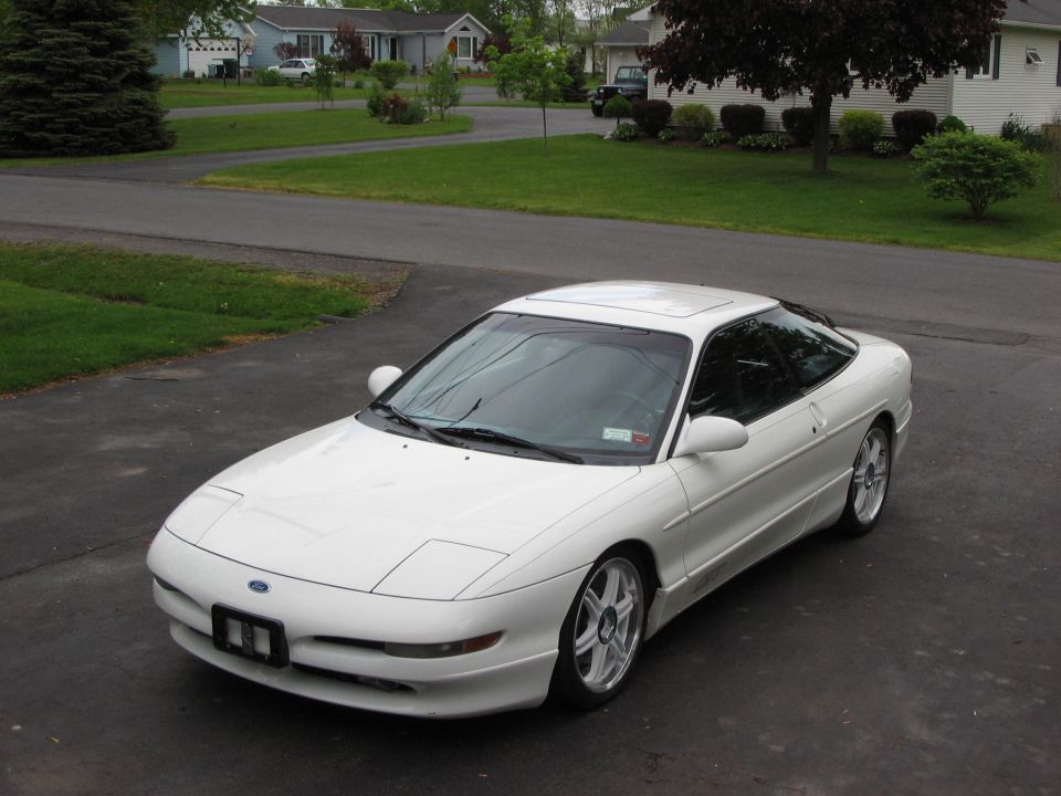 White 1993 Ford Probe coupe parked on asphalt driveway, front 3/4 view