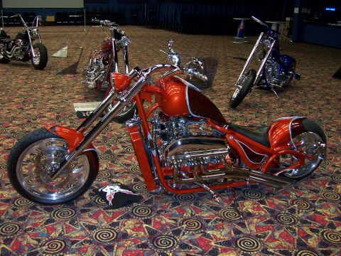 1999 Jeep TJ - Multiple custom motorcycles are displayed indoors on a patterned carpet.