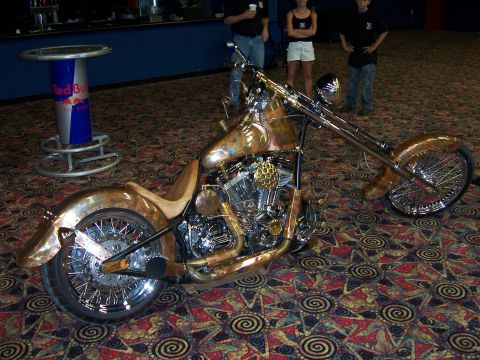 1999 Jeep TJ - A custom chopper motorcycle with a copper finish and brass accents is displayed indoors.