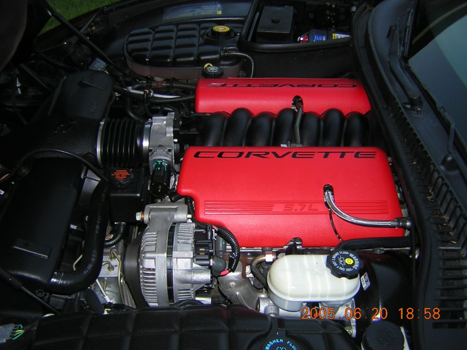 Corvette engine bay with red 5.7L V8 covers and polished alternator