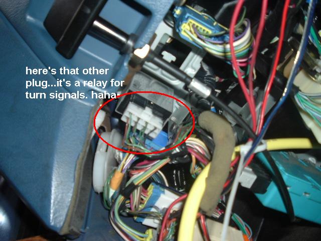 close-up of car's interior wiring with a red circle around a turn signal relay