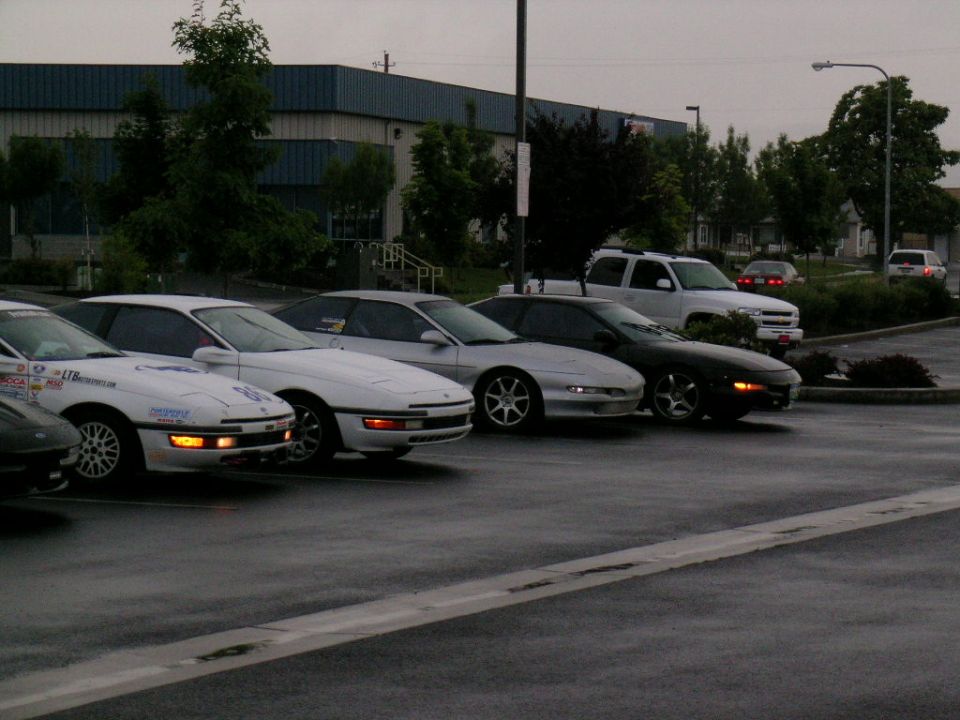 White 1993 Ford Probe with racing decals parked in a lot