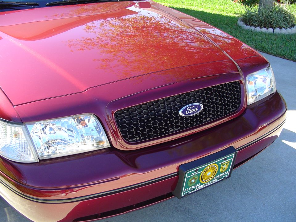 Red 2004 Ford Crown Victoria with honeycomb grille and Florida Sheriffs Association license plate