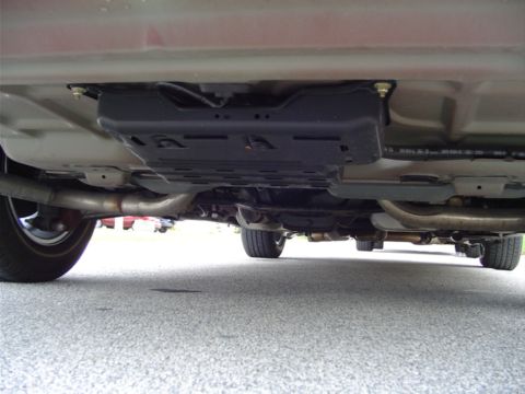 2004 Ford Crown Victoria - The underside of a vehicle reveals its exhaust system and protective underbody components.