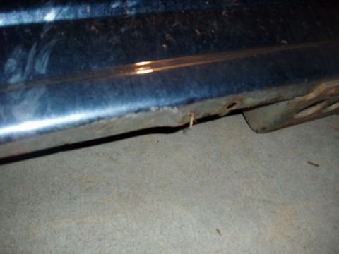 1994 Ford Bronco - Close-up of a vehicle's undercarriage showing rust and wear.