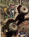 1992 Ford Bronco - This off-road vehicle is navigating a challenging dirt incline with steep sides.