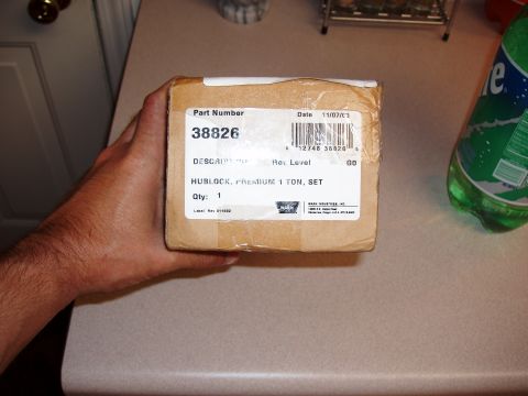 1994 Ford Bronco - A hand holds a box containing a premium 1-ton hublock set, part number 38826, with a shipping label dated 11/07/13.
