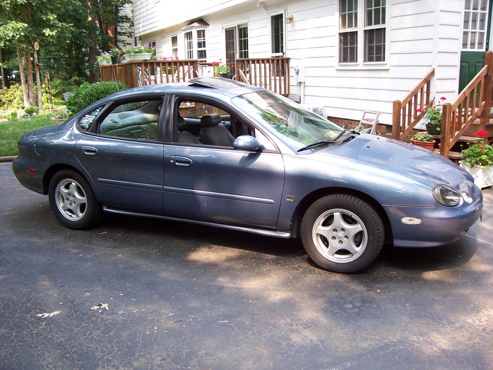 Blue 1999 Ford Taurus sedan parked in driveway