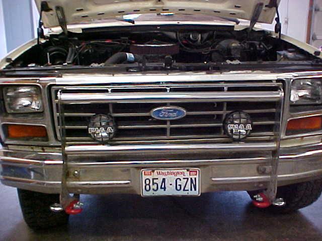 Front grille of Ford truck with chrome brush guard, PIAA lights, Washington plate 854-GZN