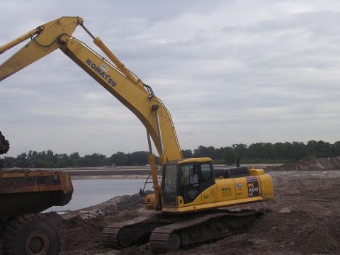 1985 Ford Bronco - A Komatsu PC 400 LC excavator is seen at a construction site, with a dump truck nearby.