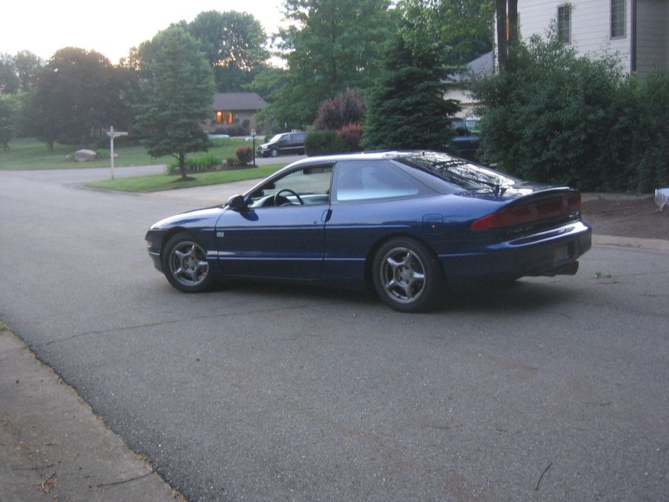Blue 1995 Ford Probe coupe parked on a suburban street, viewed from the rear quarter