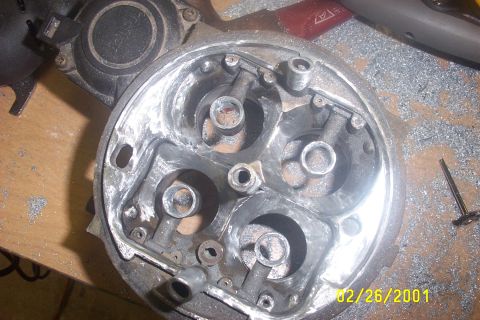 1979 Ford F-150 - A close-up view of a modified engine component, surrounded by metal debris.