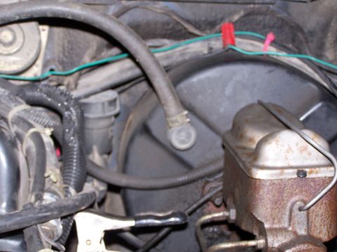 1986 Ford Bronco - This image shows a section of a vehicle's engine bay, focusing on the brake fluid reservoir and associated hoses.