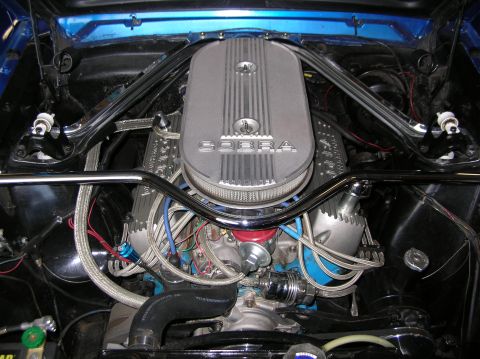 1965 Ford Mustang - Engine bay view of a Ford Cobra engine, likely from a classic Mustang.
