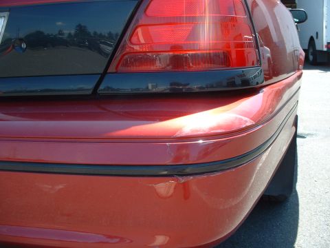 1999 Ford Crown Victoria - Someone was backing up an RV and backed into the my rear bumper while the car was parked outside in the lot of the Bill Pierre Ford service…