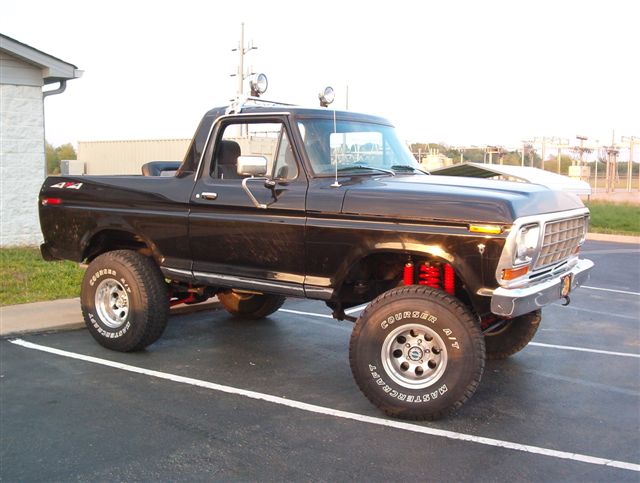 1978 Ford Bronco, black, lifted with off-road tires and red shocks