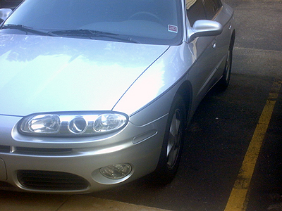 2002 Oldsmobile Aurora - Front quarter view of a silver sedan parked in a lot.