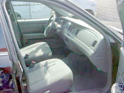 2003 Ford Crown Victoria - Interior view of a 2003 Ford Crown Victoria, highlighting the dashboard and seating.